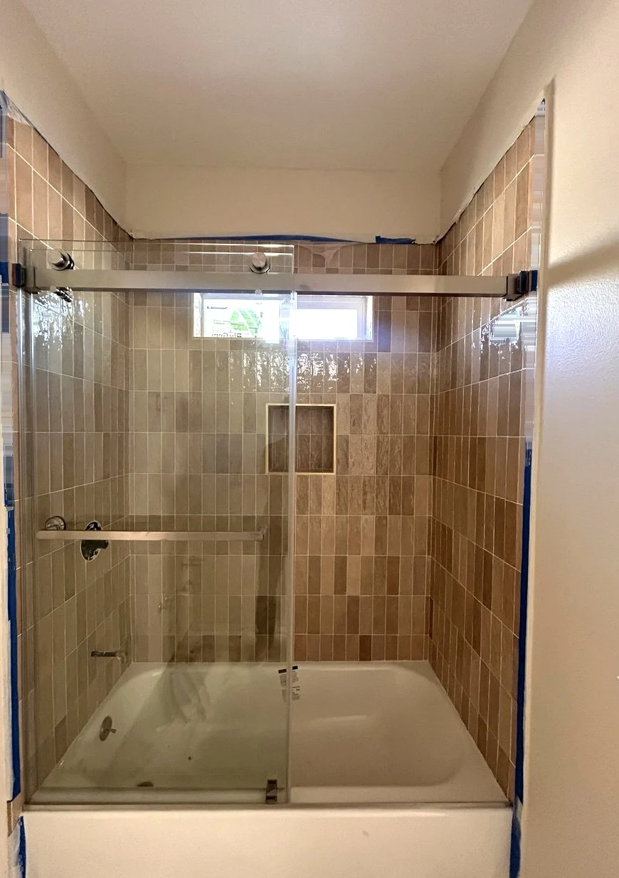 Completed double sliding bathtub shower door installation in Chino, California