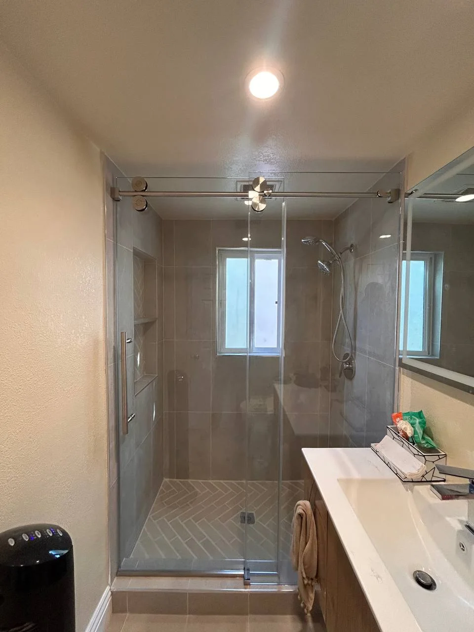 Single sliding frameless shower door with brushed nickel hardware