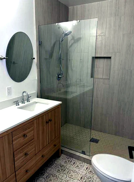 Standalone fixed shower glass panel installed for a walk-in shower in Covina